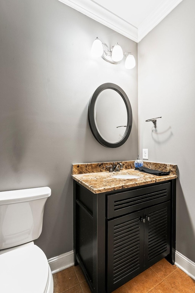 half bath featuring toilet, vanity, ornamental molding, and tile patterned floors