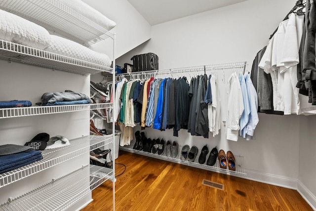 spacious closet featuring wood finished floors and visible vents