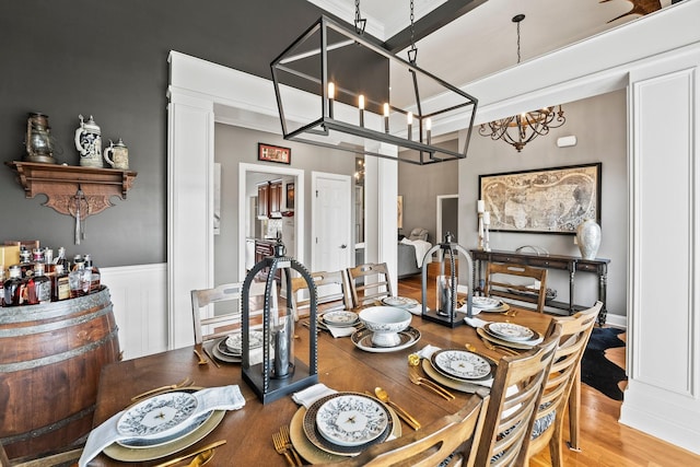 dining room with a notable chandelier and wood finished floors