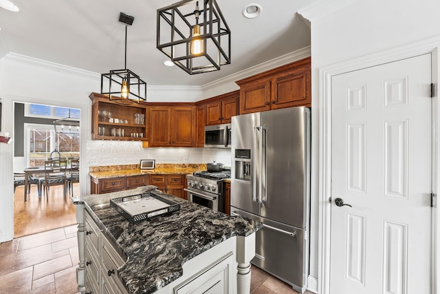 kitchen featuring pendant lighting, brown cabinets, a kitchen island, dark stone countertops, and high quality appliances