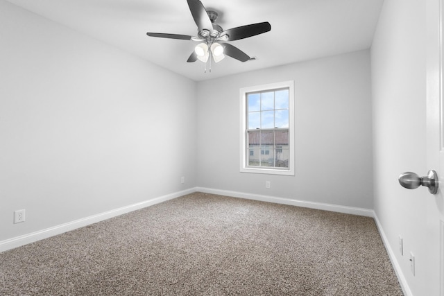 unfurnished room with a ceiling fan, carpet, and baseboards