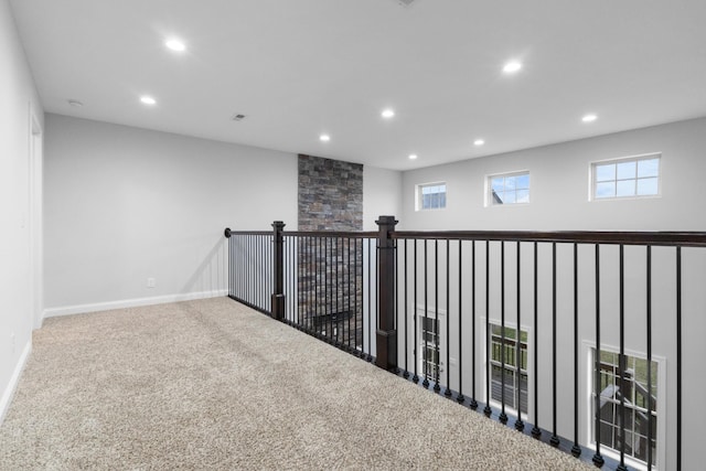 hallway featuring recessed lighting, carpet flooring, and baseboards