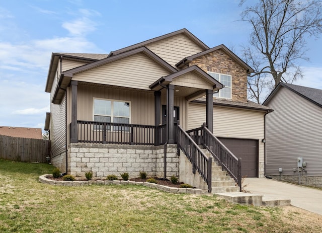 view of front of house featuring covered porch, an attached garage, fence, driveway, and a front lawn