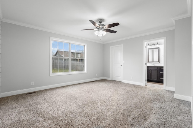 unfurnished bedroom with carpet, connected bathroom, ornamental molding, and baseboards