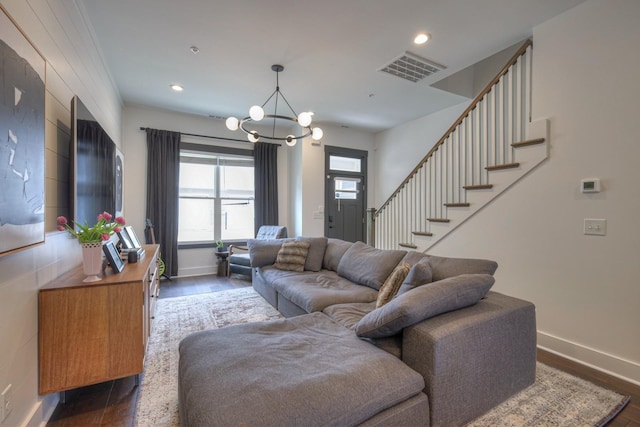 living room featuring stairway, visible vents, dark wood finished floors, recessed lighting, and a notable chandelier