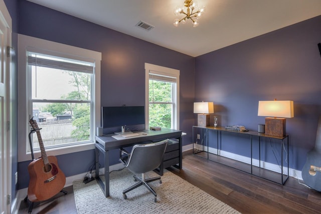 office featuring a notable chandelier, baseboards, visible vents, and dark wood-style flooring