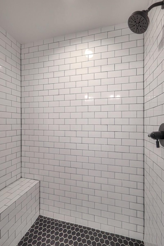 bathroom with tiled shower