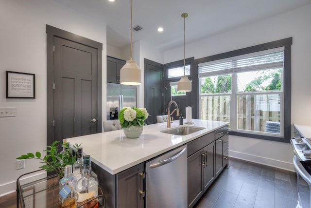 kitchen with visible vents, appliances with stainless steel finishes, light countertops, and a sink