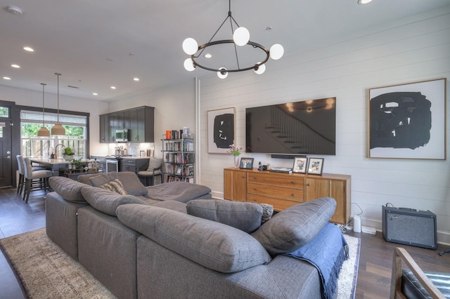 living room with recessed lighting, a notable chandelier, and wood finished floors