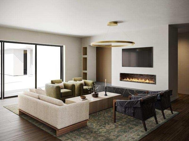 living area with a warm lit fireplace and wood finished floors