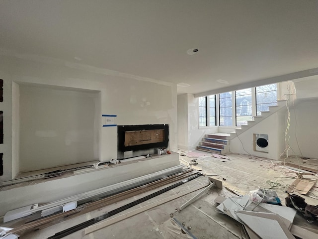 living area with stairs and heating unit