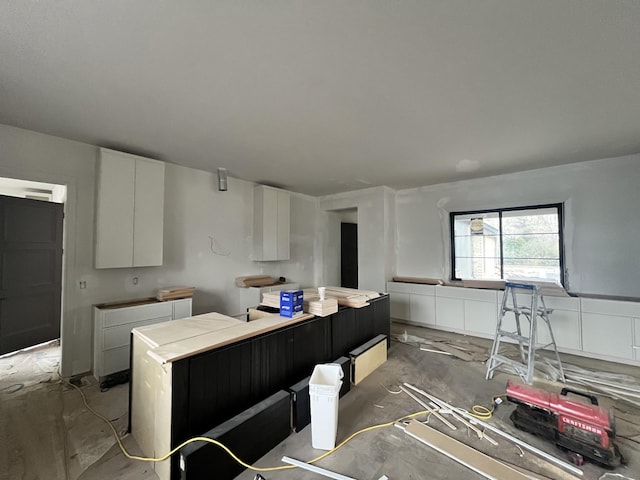 kitchen with light countertops and white cabinetry