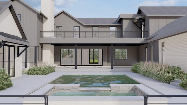 back of house with an outdoor pool, a balcony, an in ground hot tub, a patio area, and stucco siding