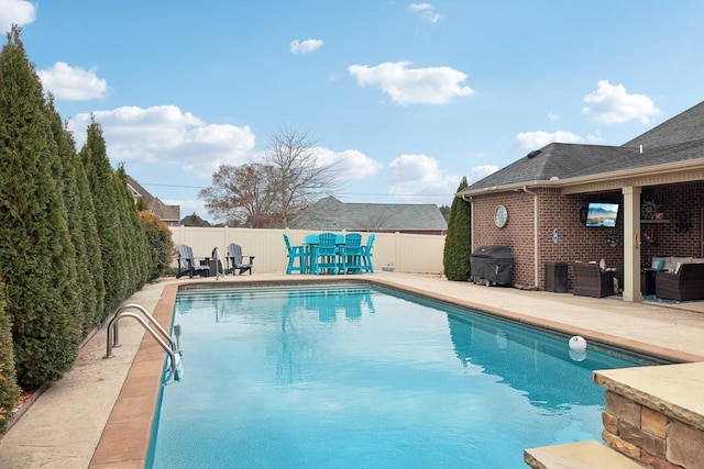 view of pool with a patio, a fenced backyard, a fenced in pool, and a grill