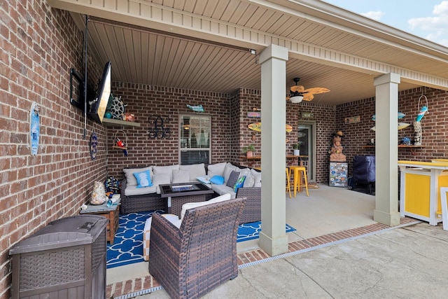 view of patio / terrace with ceiling fan, an outdoor living space, and an outdoor bar