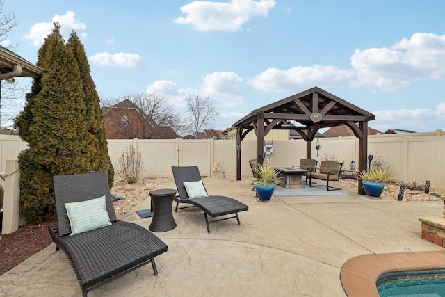 view of patio / terrace with a fire pit, a gazebo, and a fenced backyard