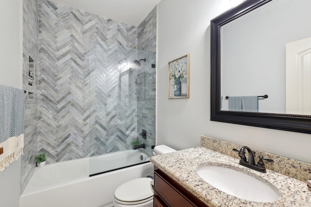 full bathroom featuring toilet, combined bath / shower with glass door, and vanity