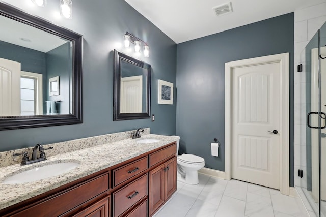 bathroom with visible vents, a sink, a shower stall, and toilet