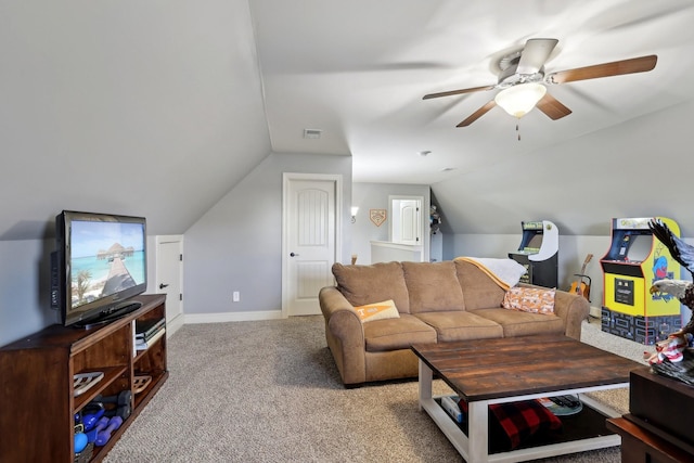 living room featuring visible vents, light carpet, vaulted ceiling, ceiling fan, and baseboards