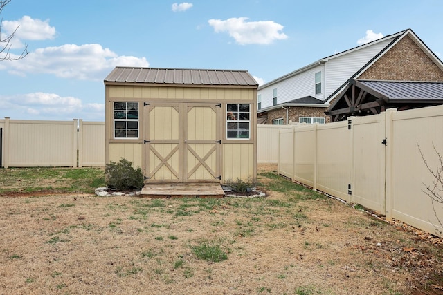 view of shed with a gate and a fenced backyard