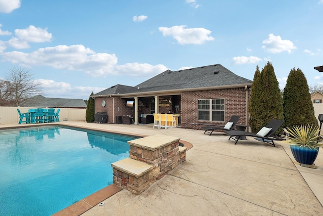 view of swimming pool featuring a fenced in pool, a patio area, and fence