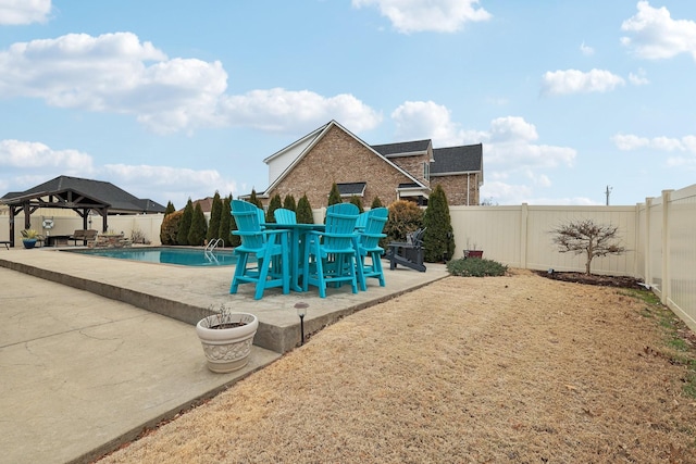 view of pool featuring a gazebo, a patio, a fenced backyard, and a fenced in pool