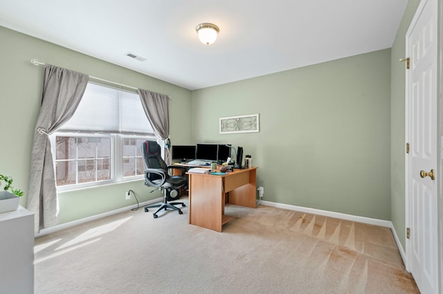 office area featuring visible vents, light carpet, and baseboards