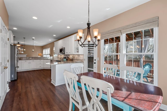 dining room featuring a chandelier, dark wood-style flooring, and recessed lighting