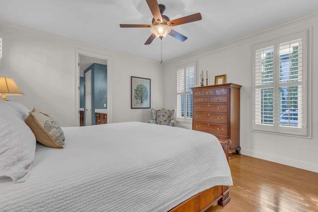 bedroom featuring light wood finished floors, ornamental molding, multiple windows, and baseboards