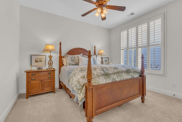 bedroom featuring baseboards, a ceiling fan, visible vents, and light colored carpet