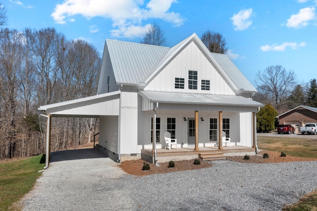 modern farmhouse style home with metal roof, covered porch, driveway, crawl space, and a carport