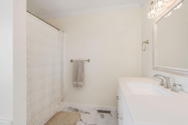 full bath with a chandelier, vanity, baseboards, marble finish floor, and ornamental molding