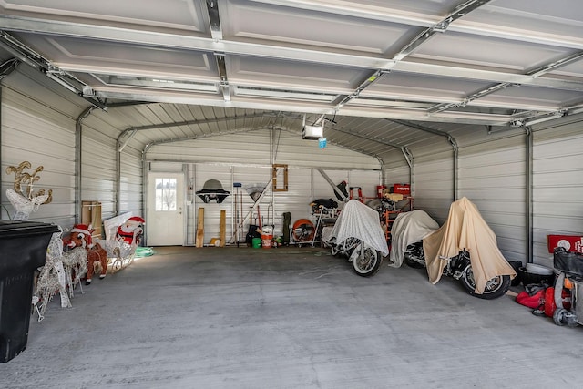 garage with a garage door opener and metal wall