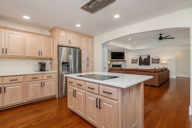 kitchen featuring black electric cooktop, visible vents, open floor plan, light countertops, and stainless steel fridge with ice dispenser