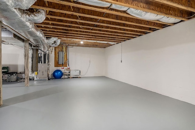 unfinished basement with electric panel and heating unit