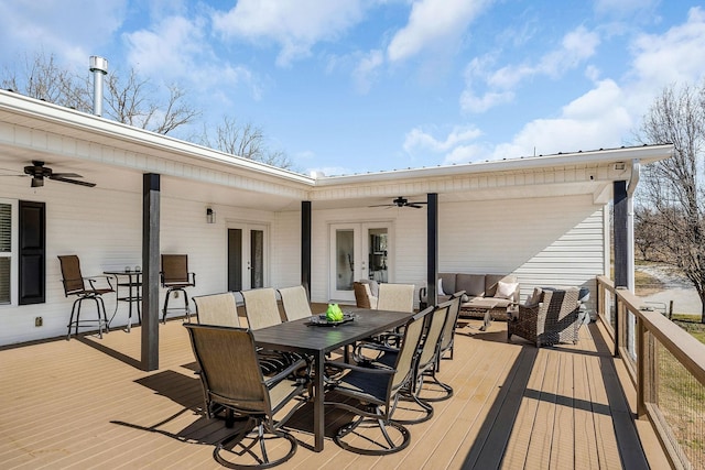 wooden deck with outdoor lounge area, french doors, outdoor dining space, and a ceiling fan