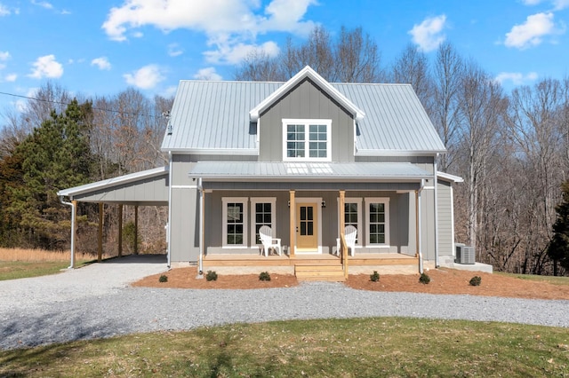 modern inspired farmhouse featuring metal roof, central AC unit, covered porch, driveway, and a carport