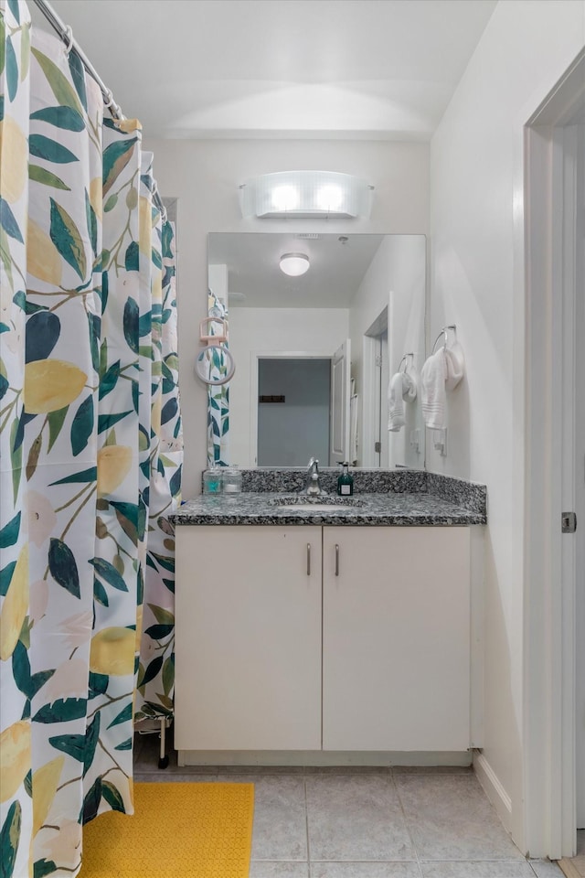 bathroom featuring tile patterned flooring and vanity