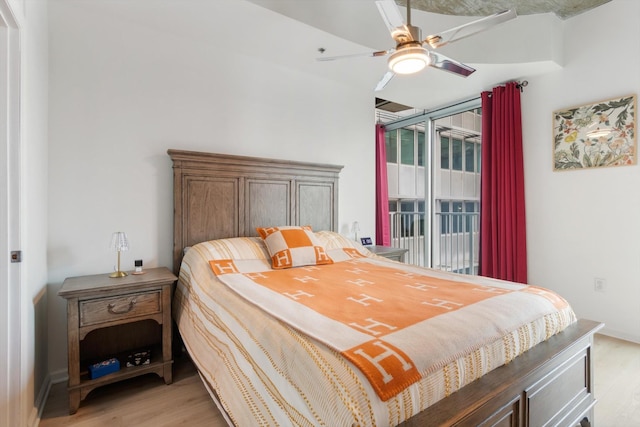 bedroom with light wood-type flooring, a ceiling fan, and access to exterior