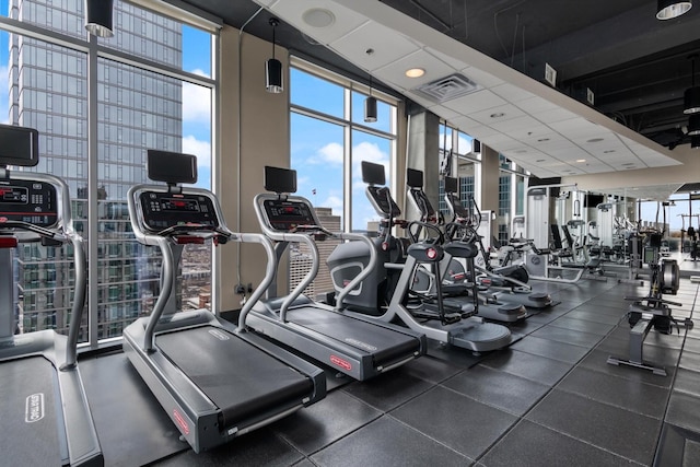 exercise room with visible vents and floor to ceiling windows