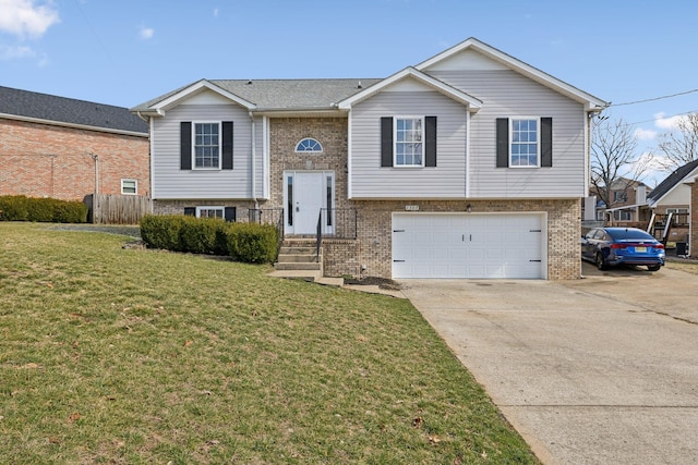 bi-level home with a garage, a front lawn, concrete driveway, and brick siding