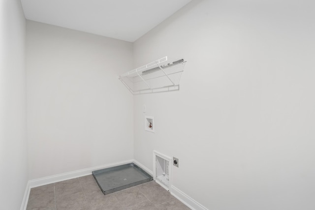 washroom featuring light tile patterned floors, hookup for a washing machine, electric dryer hookup, laundry area, and baseboards