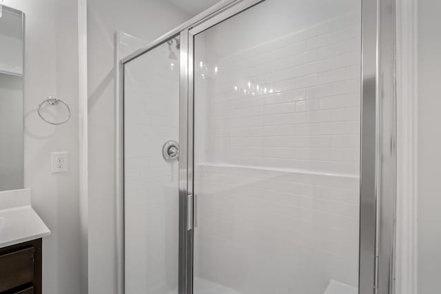 bathroom featuring a shower stall and vanity