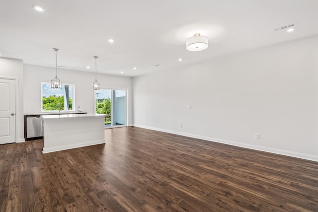 kitchen featuring recessed lighting, stainless steel dishwasher, a center island, dark wood finished floors, and pendant lighting