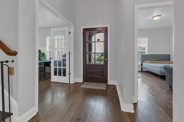 entryway with dark wood-style flooring and baseboards