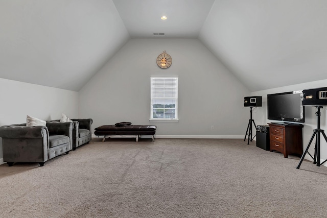 interior space with light colored carpet, visible vents, vaulted ceiling, and baseboards