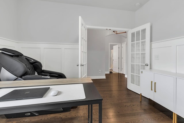 office with dark wood-style floors, a wainscoted wall, and french doors