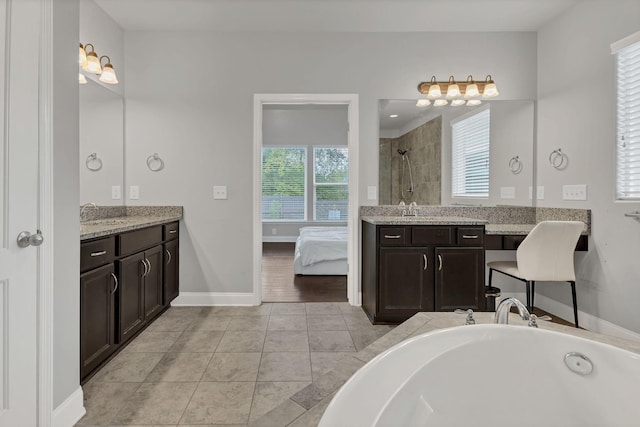 full bathroom featuring baseboards, ensuite bathroom, tile patterned flooring, vanity, and a shower stall