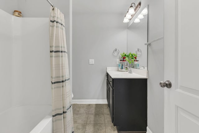 full bath with tile patterned floors, shower / bathtub combination with curtain, baseboards, and vanity