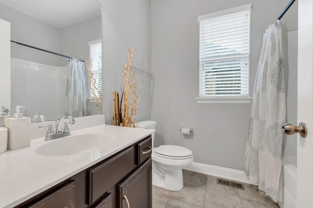 bathroom with shower / bath combination with curtain, visible vents, vanity, baseboards, and tile patterned floors